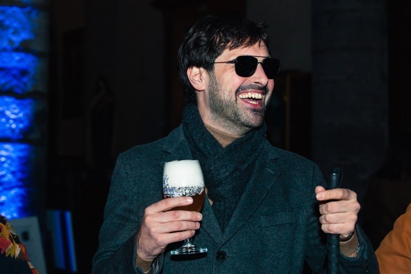 Karl Meesters, founder of rien à voir, after the concert, laughing with a drink at hand